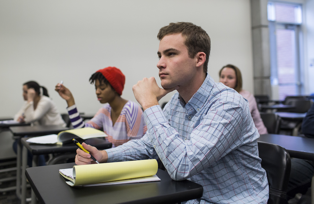 Students listening intently in a classroom.